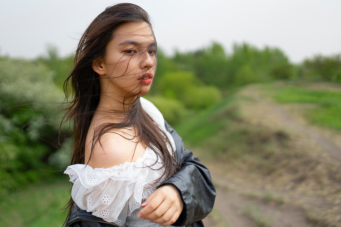 Portrait of teenage girl (16-17) looking at camera in nature