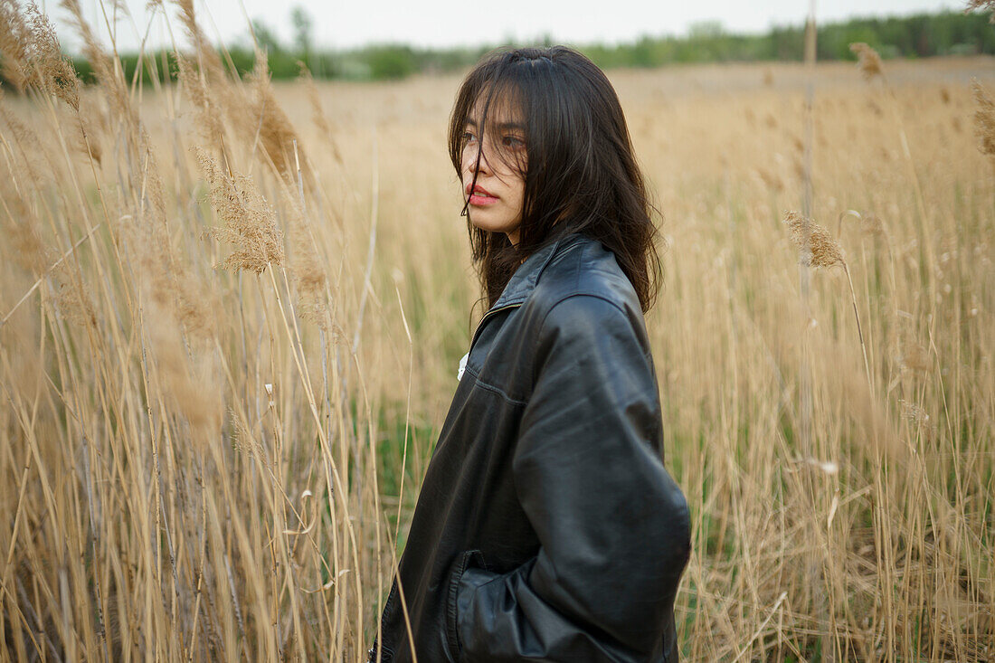 Portrait of teenage girl (16-17) standing in field 