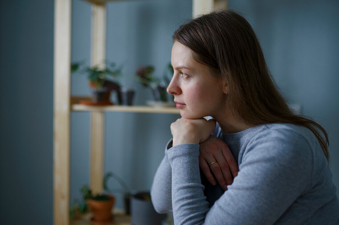 Portrait of thoughtful woman with hands on chin 