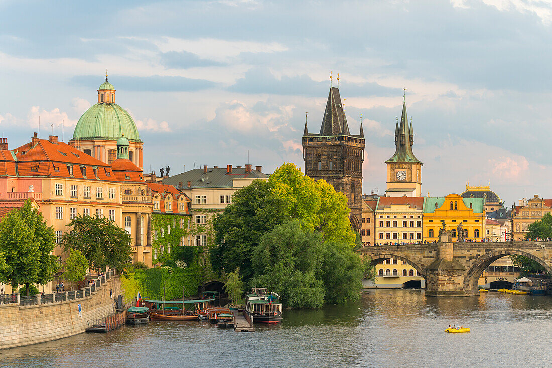 Charles Bridge and Church of Saint Francis of Assisi with Old Town Bridge Tower against sky, UNESCO World Heritage Site, Prague, Bohemia, Czech Republic (Czechia), Europe