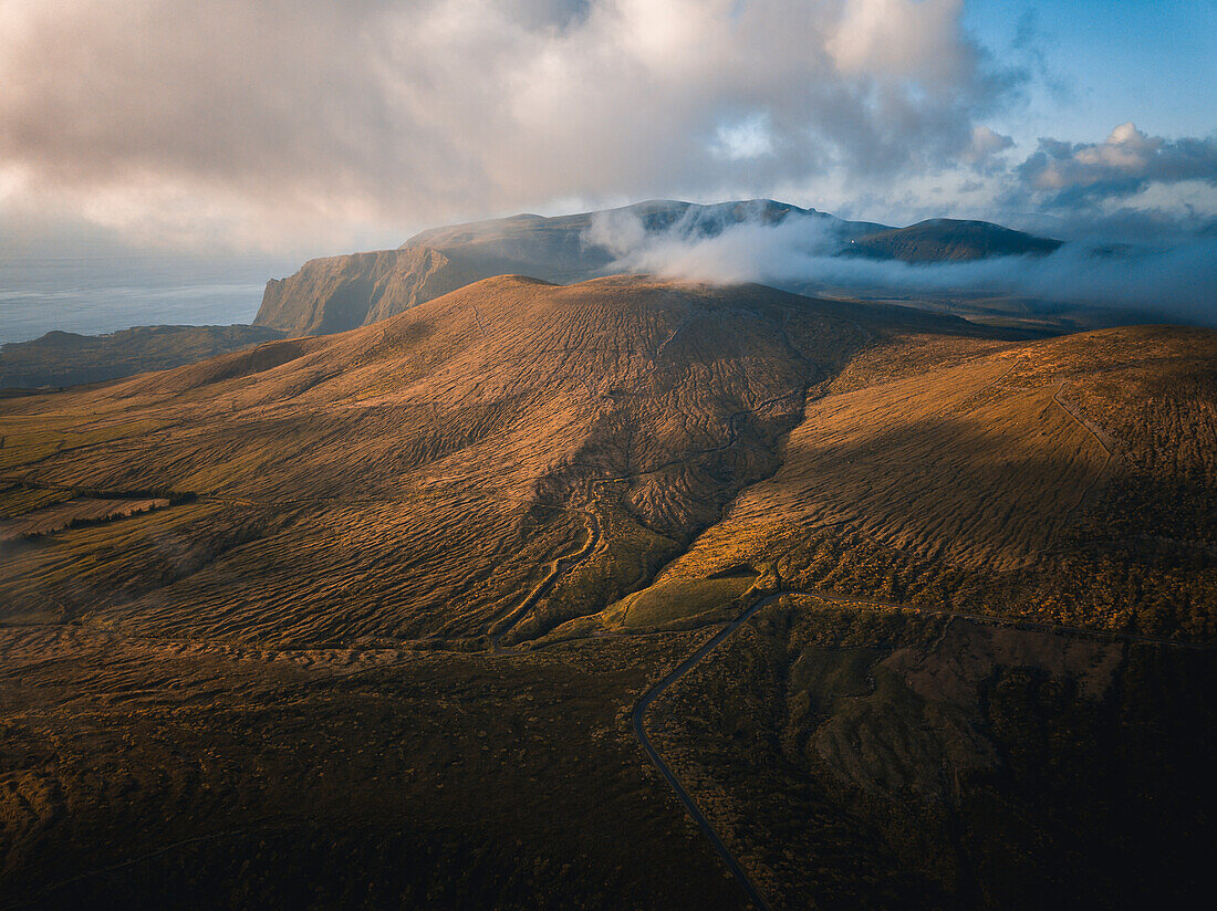 Aerial view at sunset of clouds over Flores island's mountains, Azores islands, Portugal, Atlantic, Europe