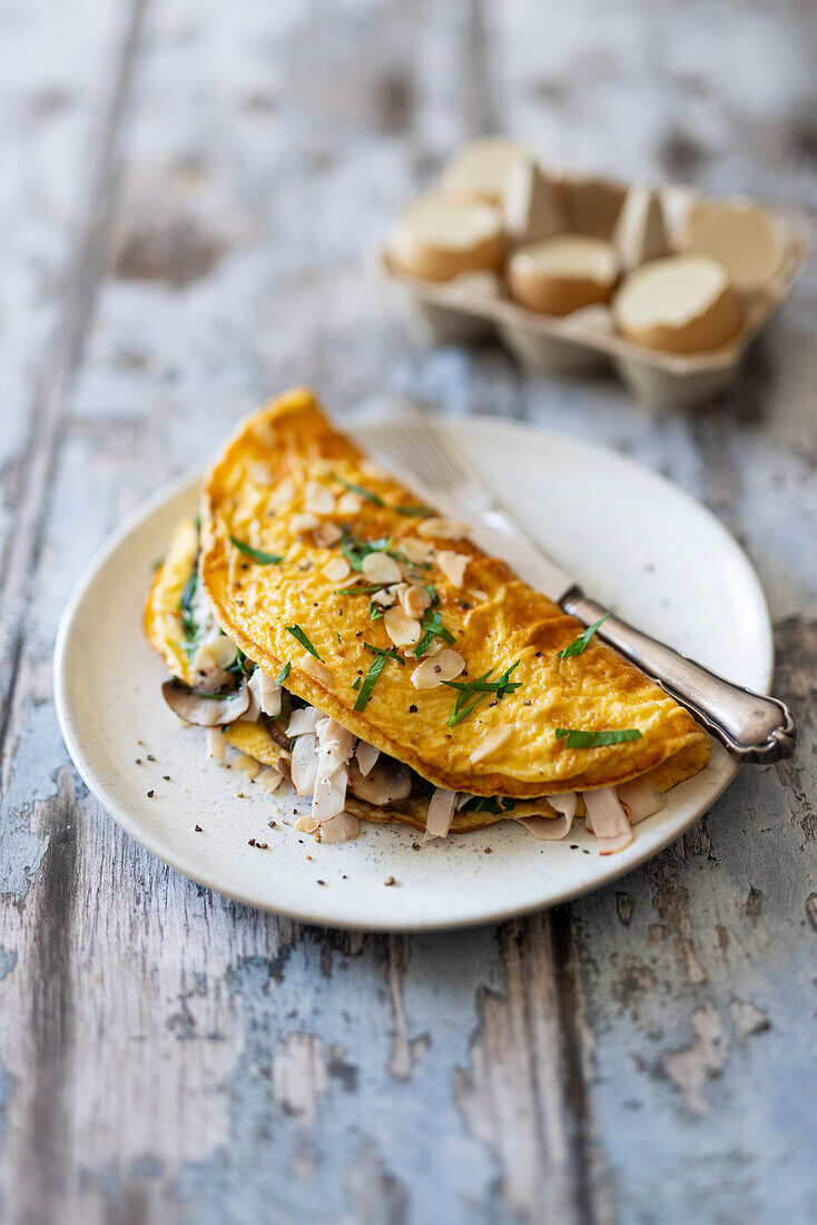 Omelet with mushrooms, spinach and turkey breast slices