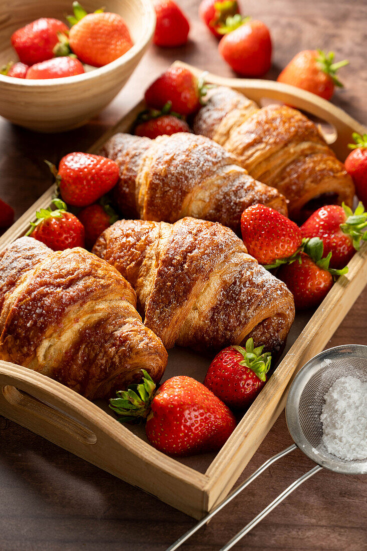 Classic French croissants with fresh strawberries