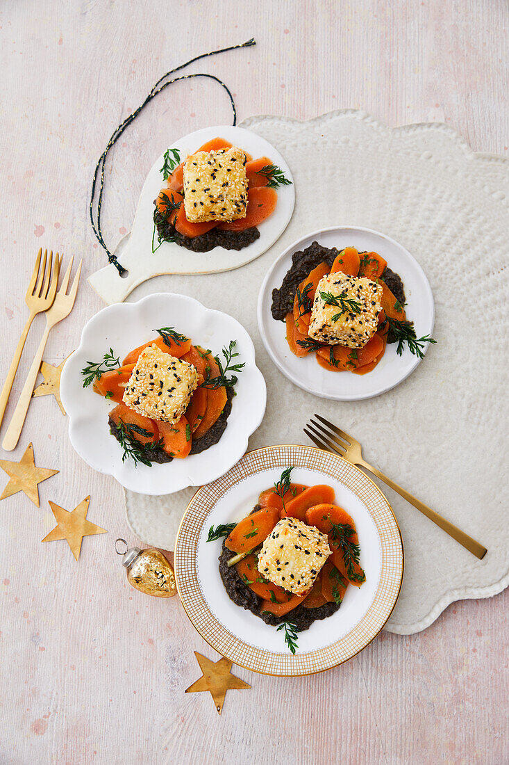 Breaded feta cheese on fermented carrots, olive paste, and carrot greens