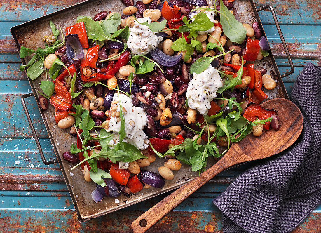 Oven baked beans with red onions, red peppers, and arugula