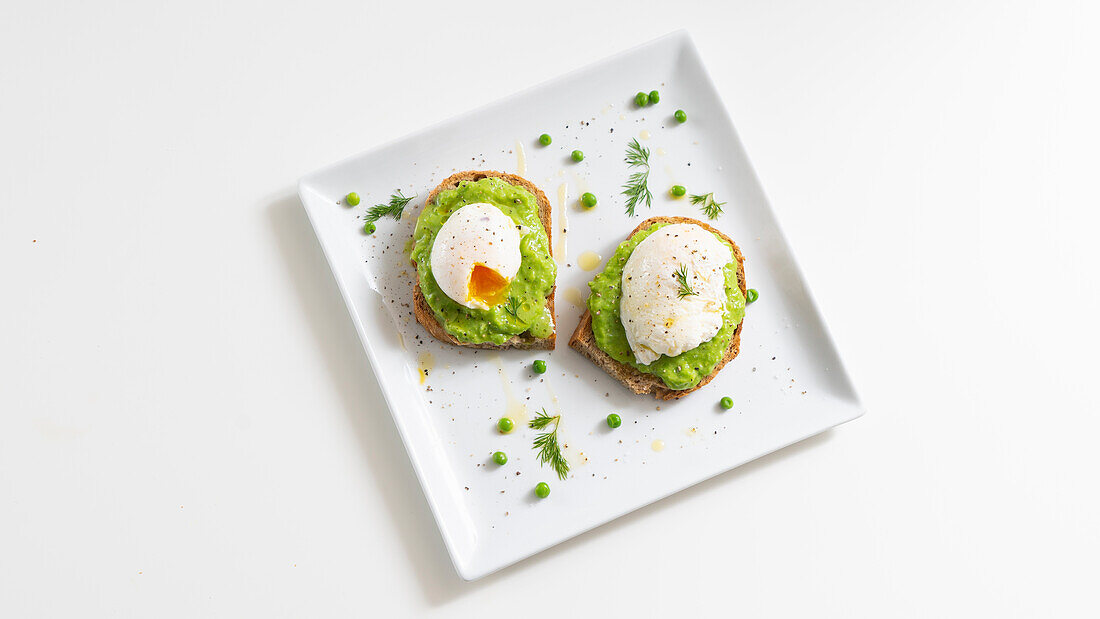 Poached egg on toasted whole grain bread with pea cream
