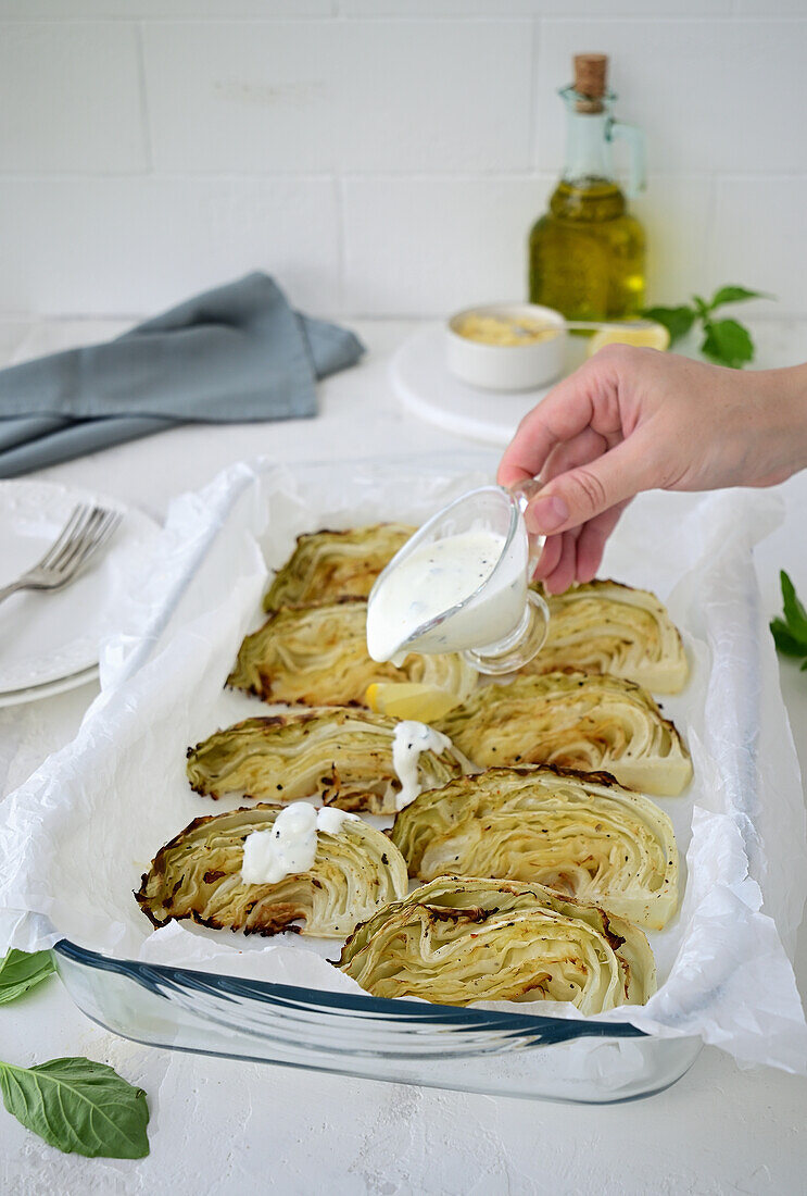 Oven baked white cabbage with yogurt sauce
