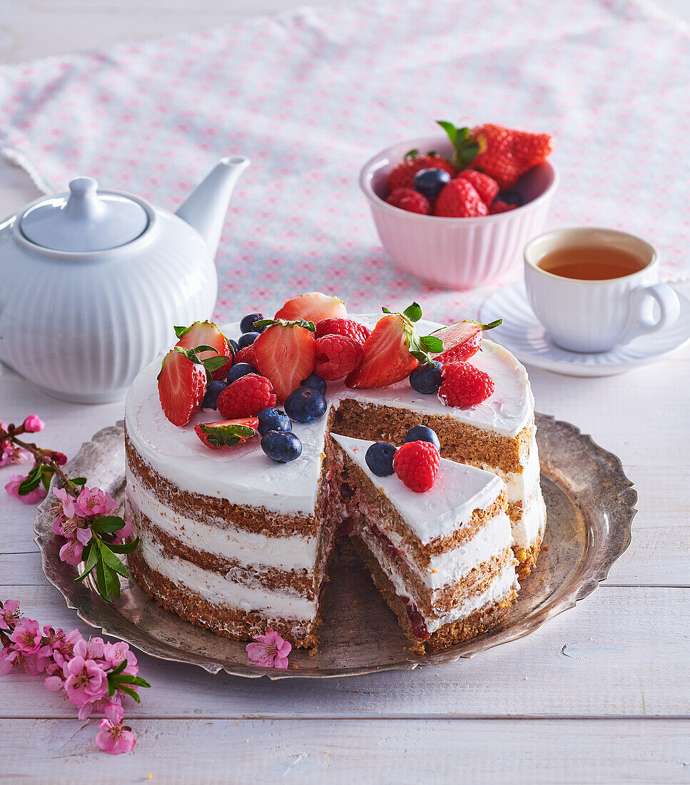Walnut cake with whipped cream and fresh fruit