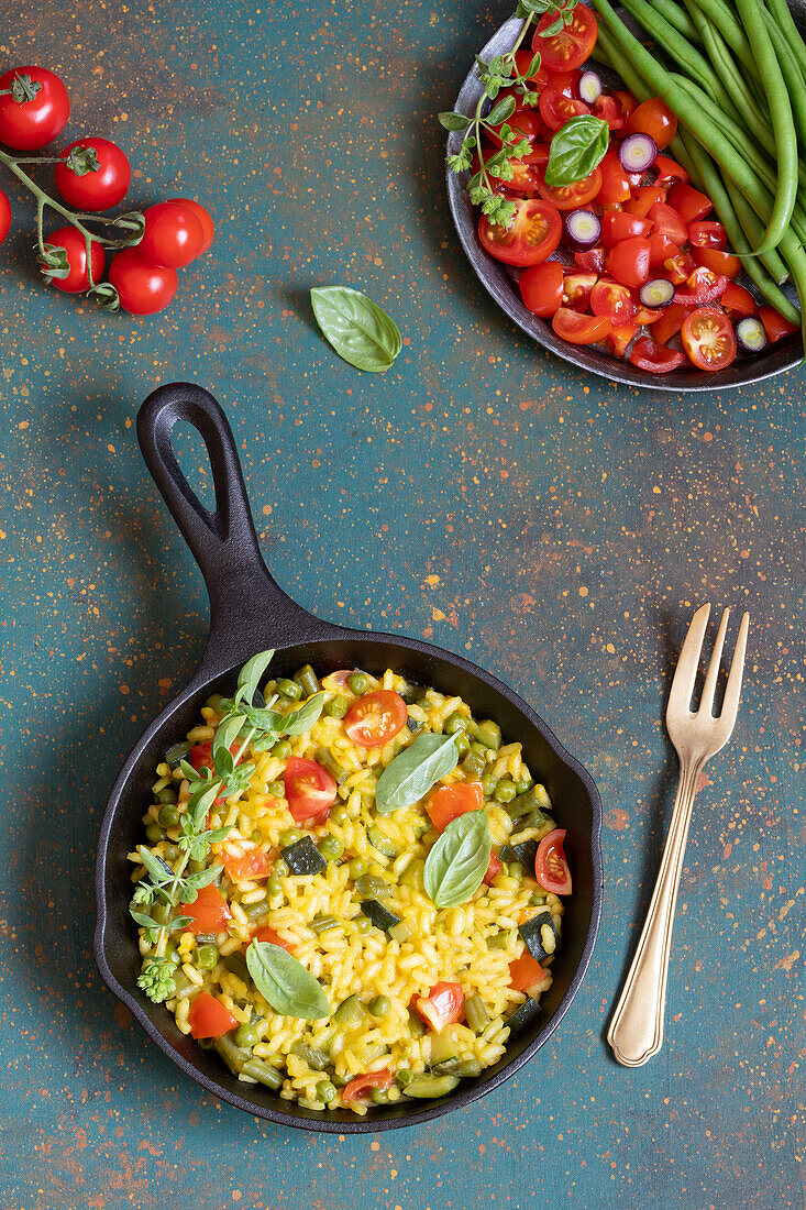 Vegetarian paella with peas, green beans, and tomatoes