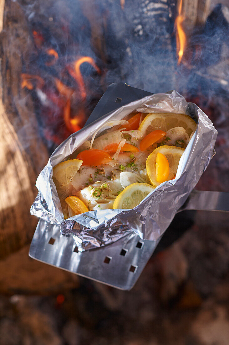 Barracuda with vegetables cooked in foil