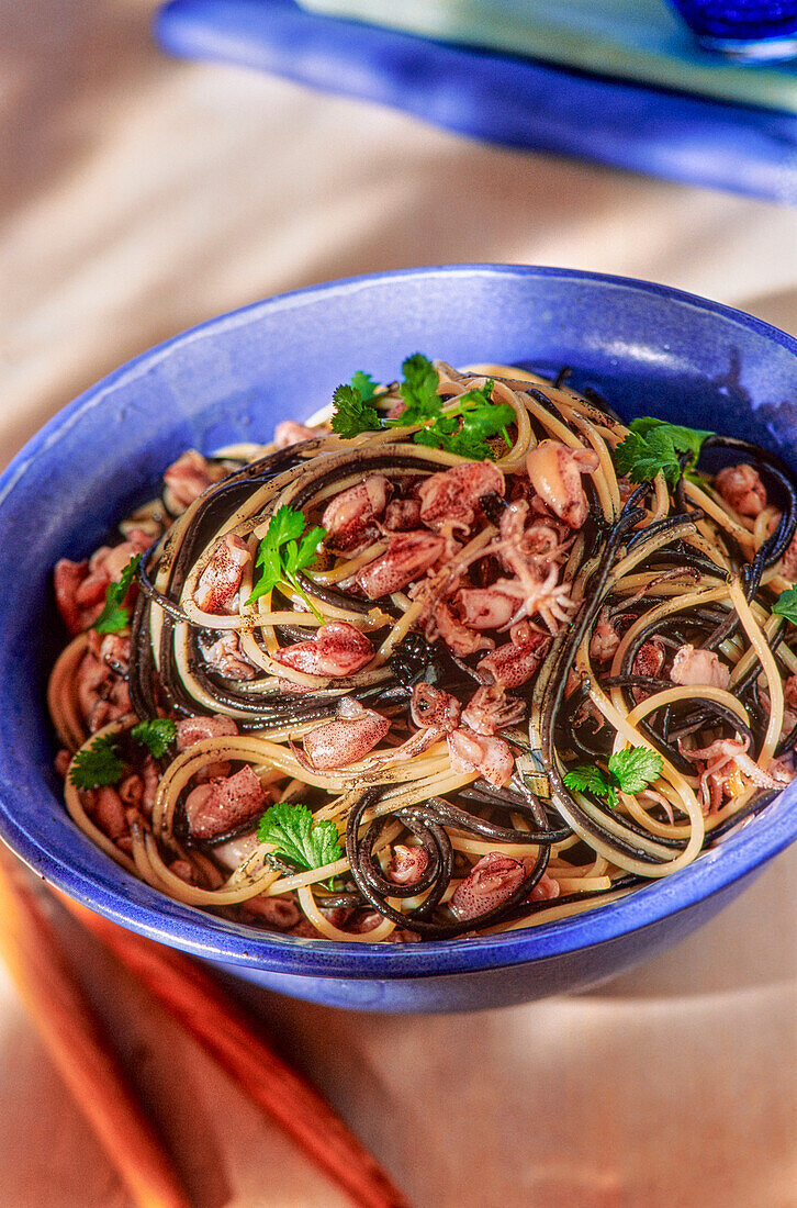 Two different colored spaghetti with squid