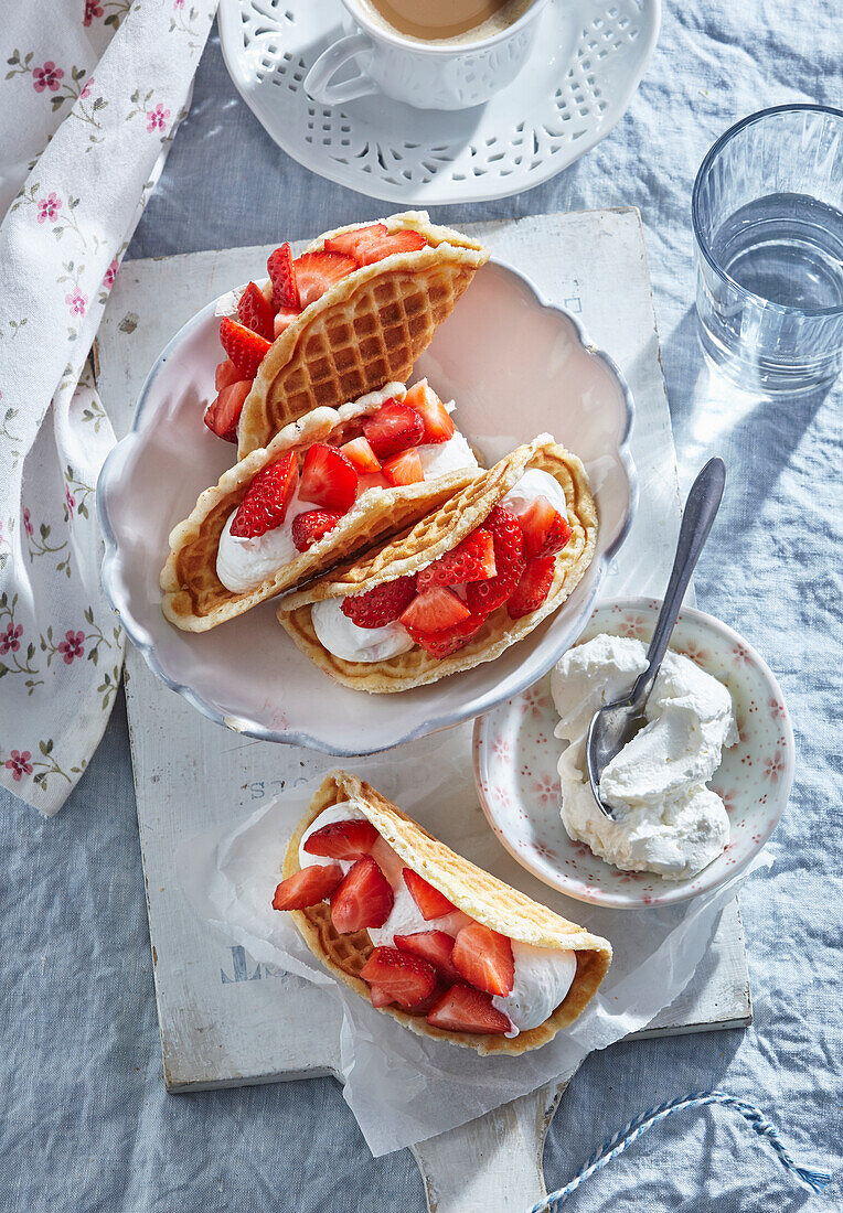 Sweet waffle tacos with strawberries and whipped cream