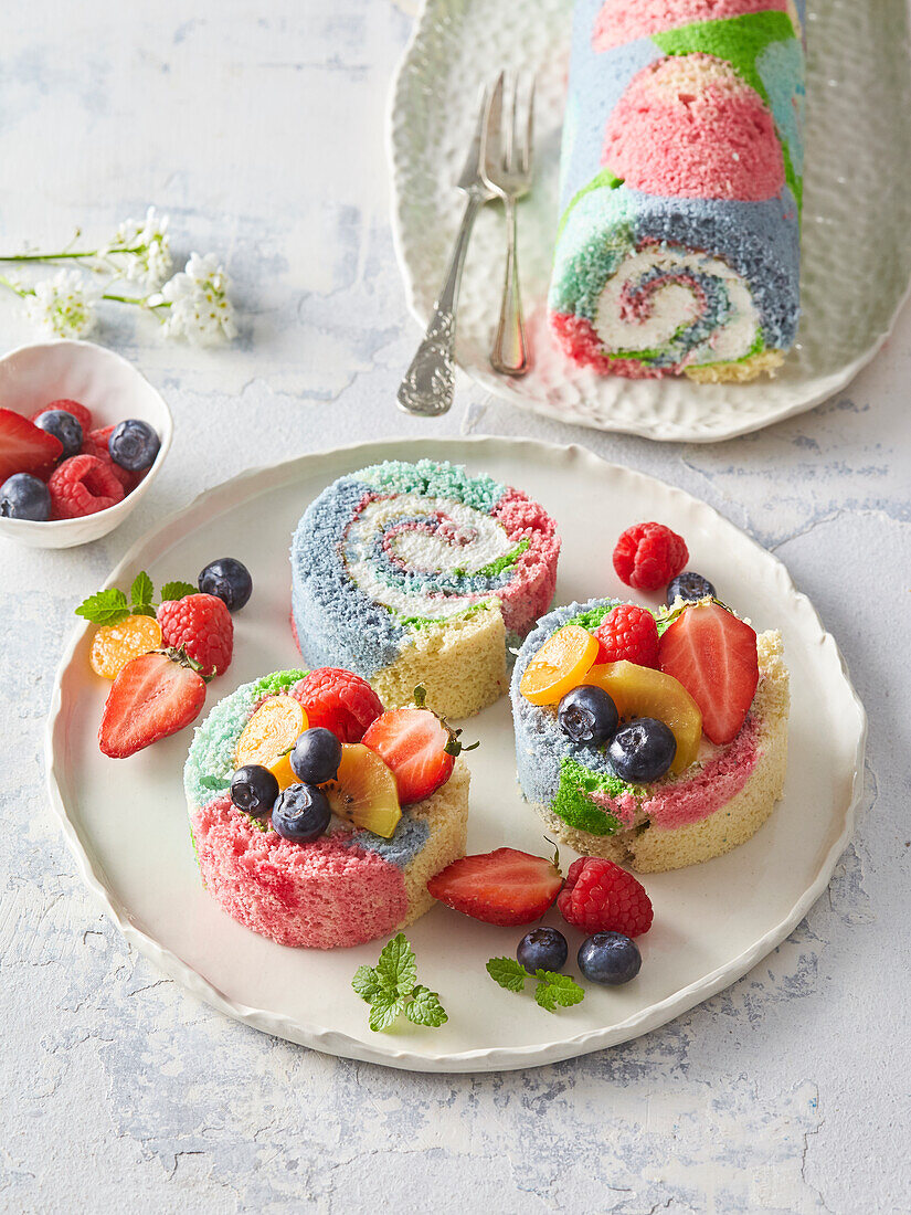 Colourful rainbow sponge cake with fresh fruit