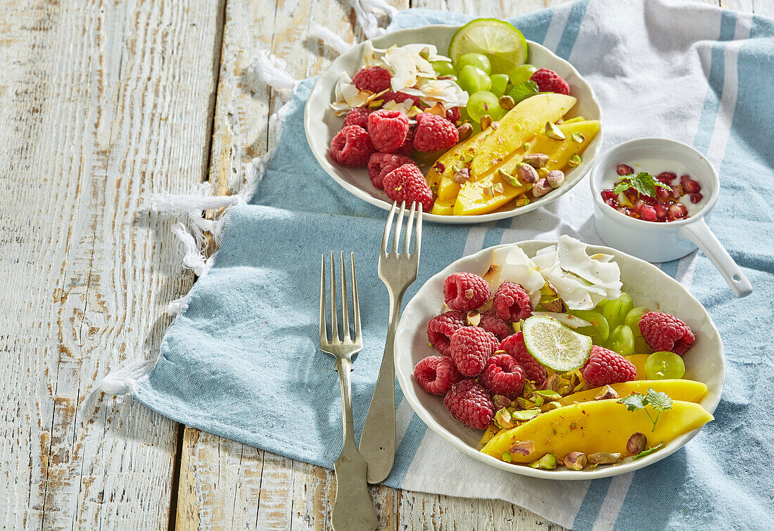 Fruit salad with mango, raspberries, grapes and yogurt