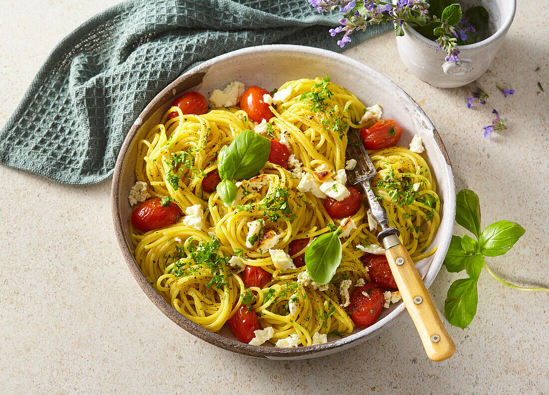 Spaghetti with feta cheese, tomatoes and basil