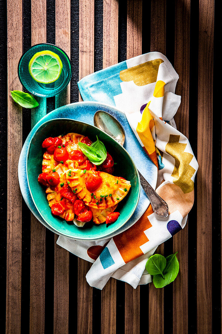 Fresh goat cheese pasta pockets with stewed tomatoes