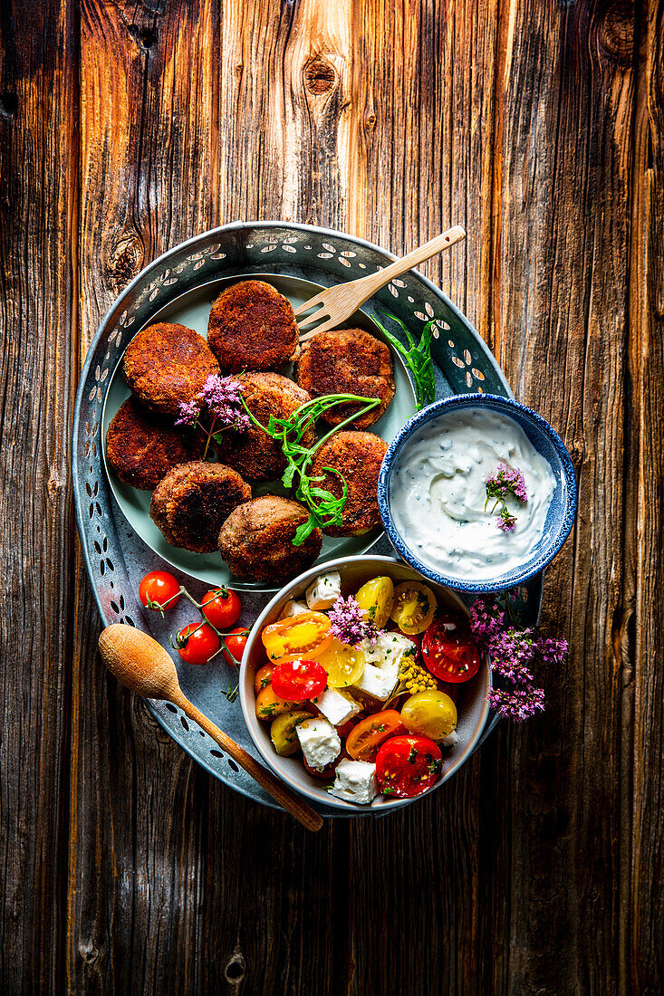 Potato and bean pancakes with tomato salad and curd dip