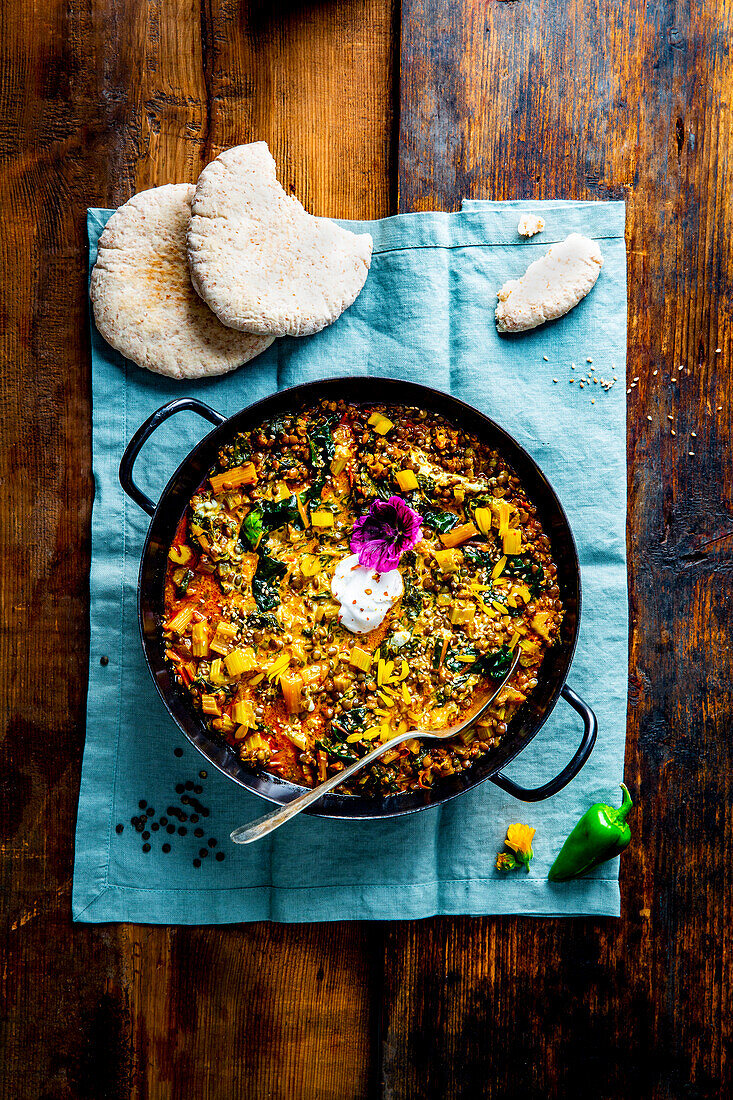 Chard-lentil stew with pita bread and natural yogurt