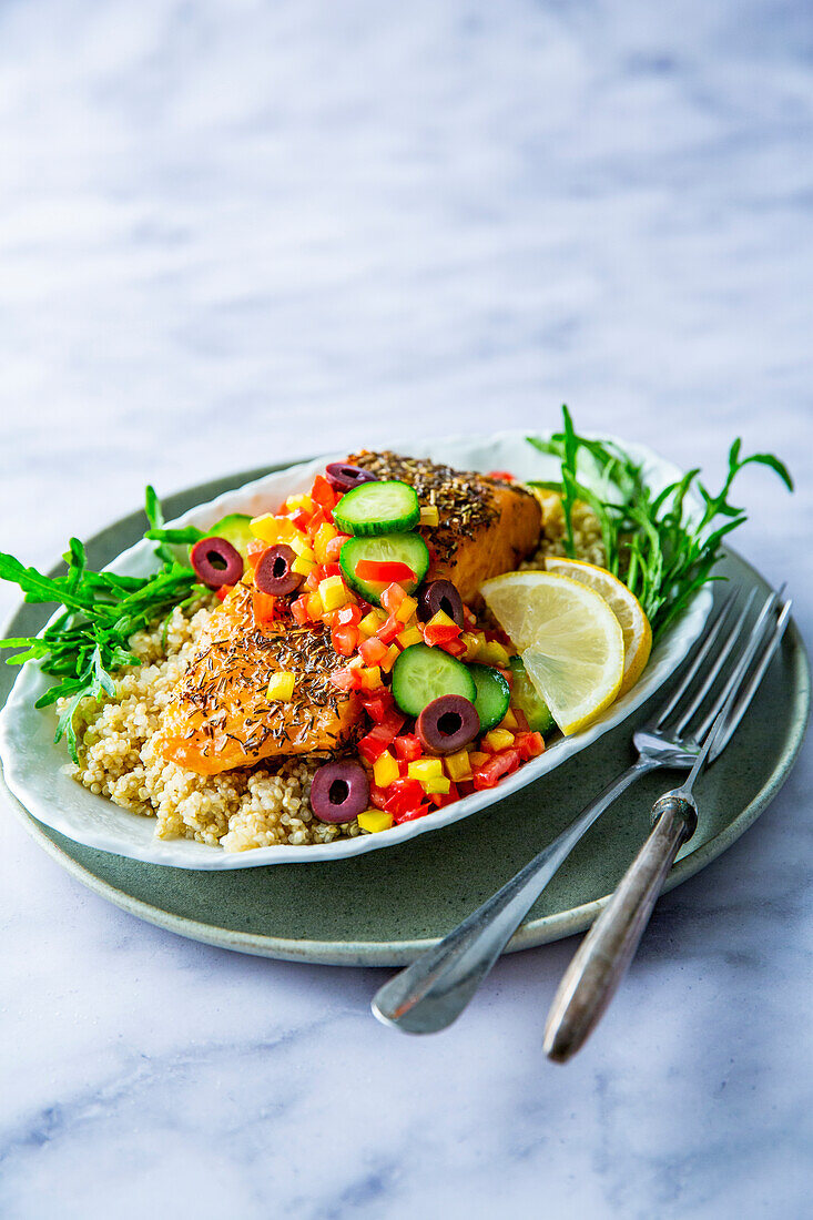 Quinoa bowl with salmon, arugula and summer vegetables