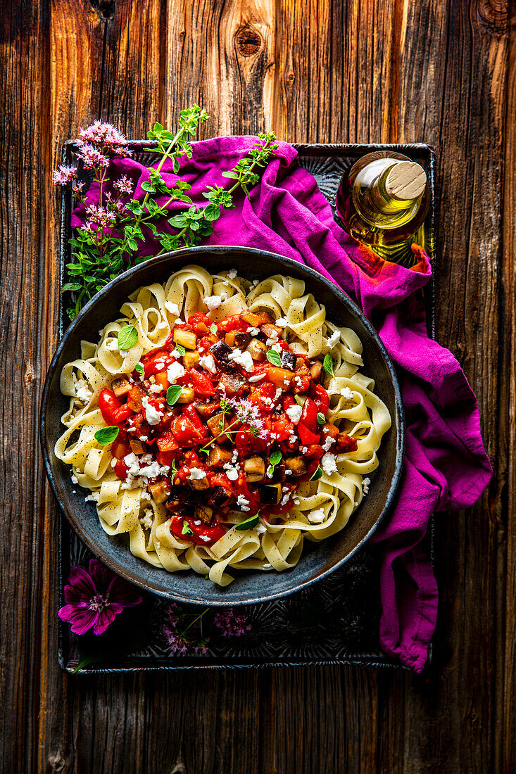 Eggplant-garlic ribbon noodles with tomato sauce and manouri cheese