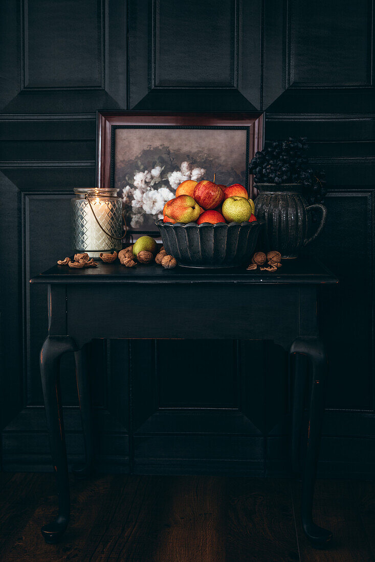 Still life with autumn fruits in a black ambience