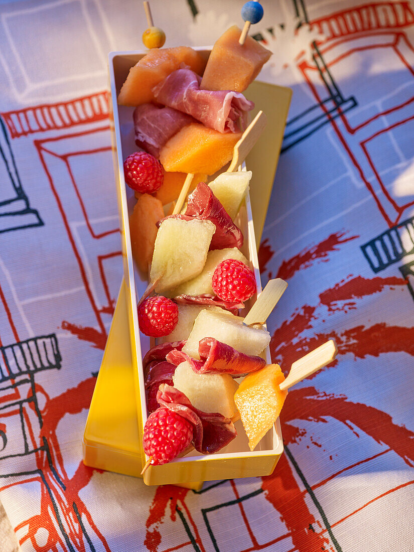 Melon, berry and ham skewers