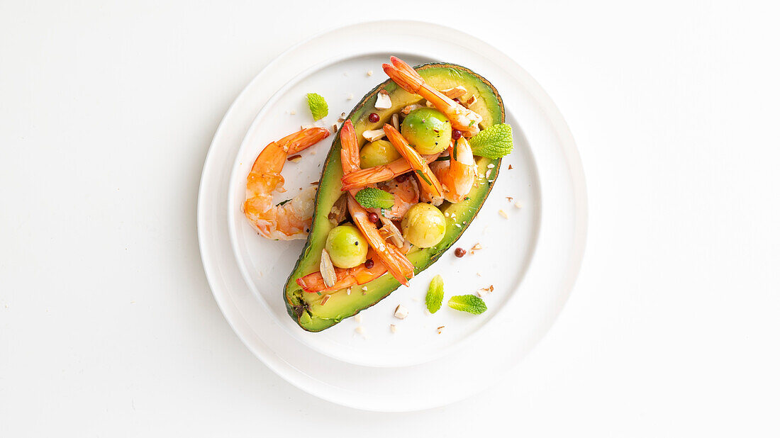 Avocado stuffed with marinated shrimp and pink peppercorns