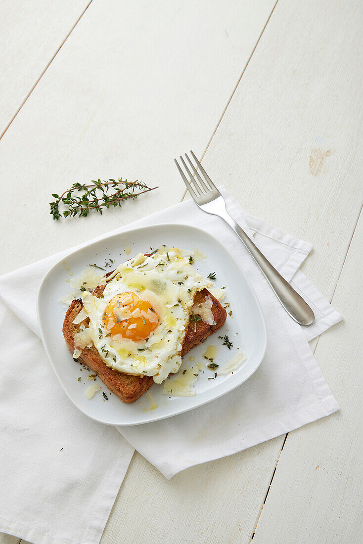 Crostini with fried egg and pecorino cheese