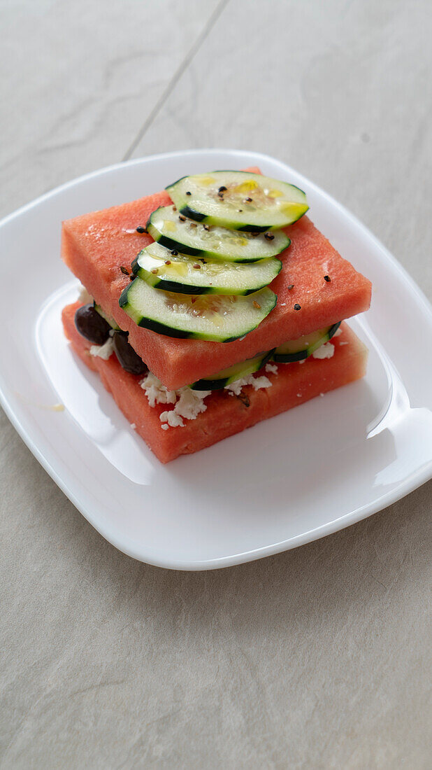 Watermelon sandwich with cucumber, olives, and feta