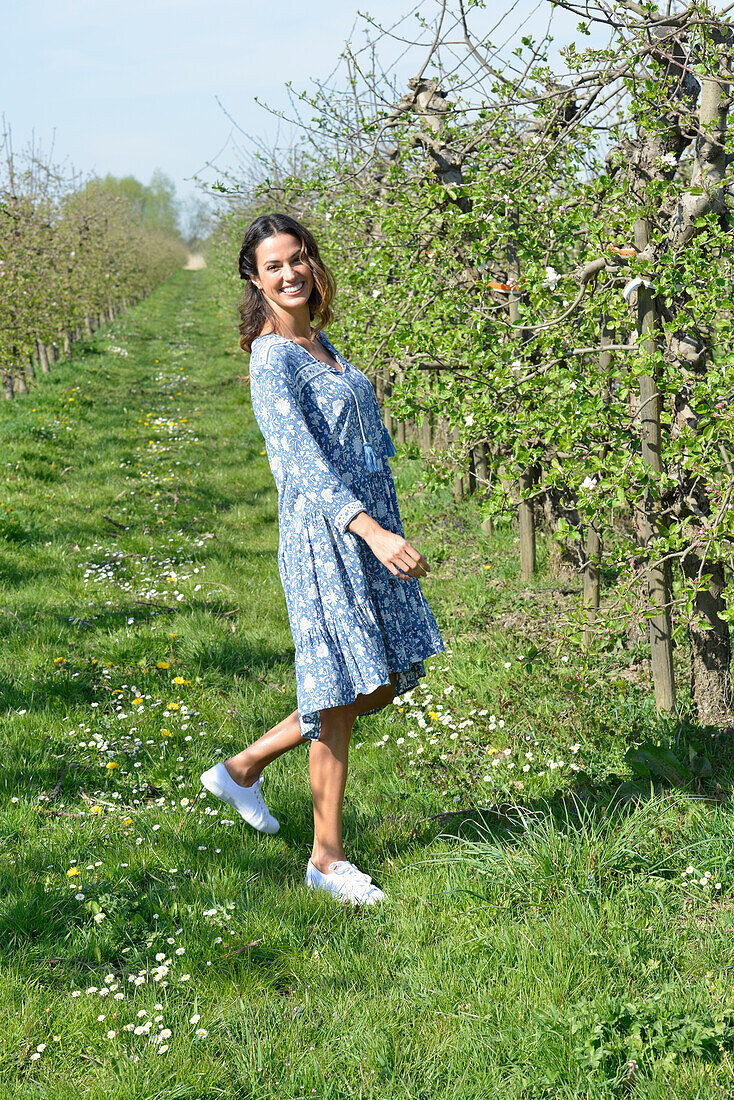 Brunette woman walking in the garden