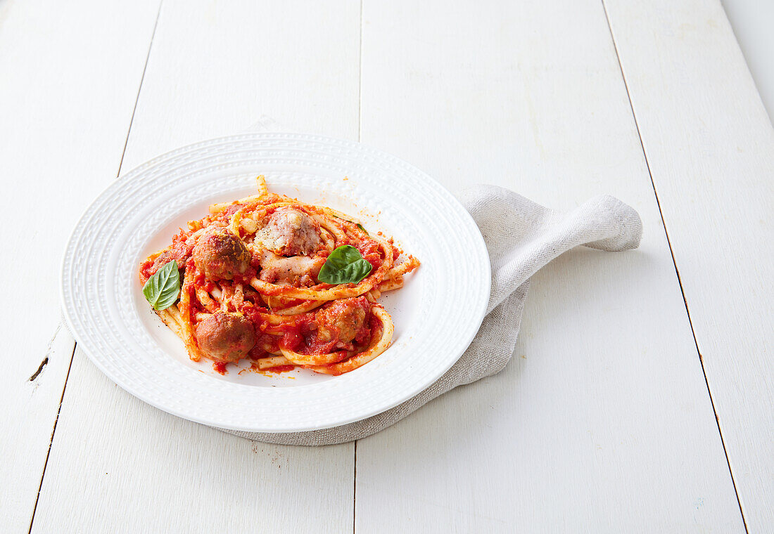 Scalloped bucatini with tomato sauce and meatballs