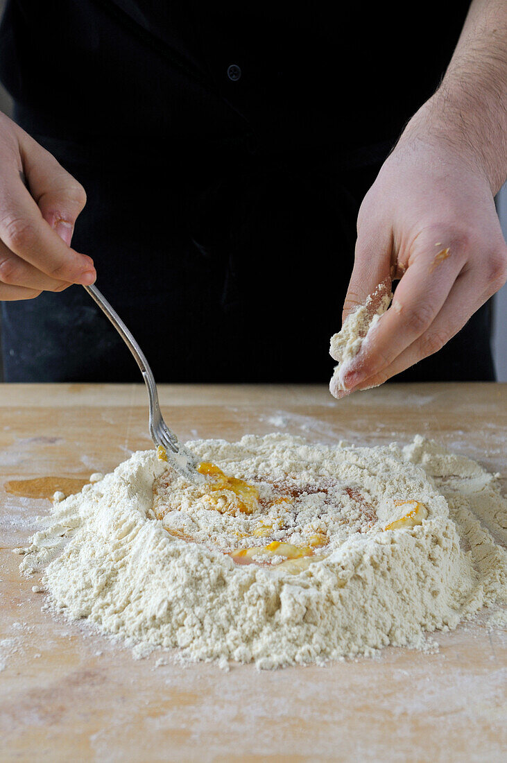 Making pasta dough: Mixing the egg with the flour