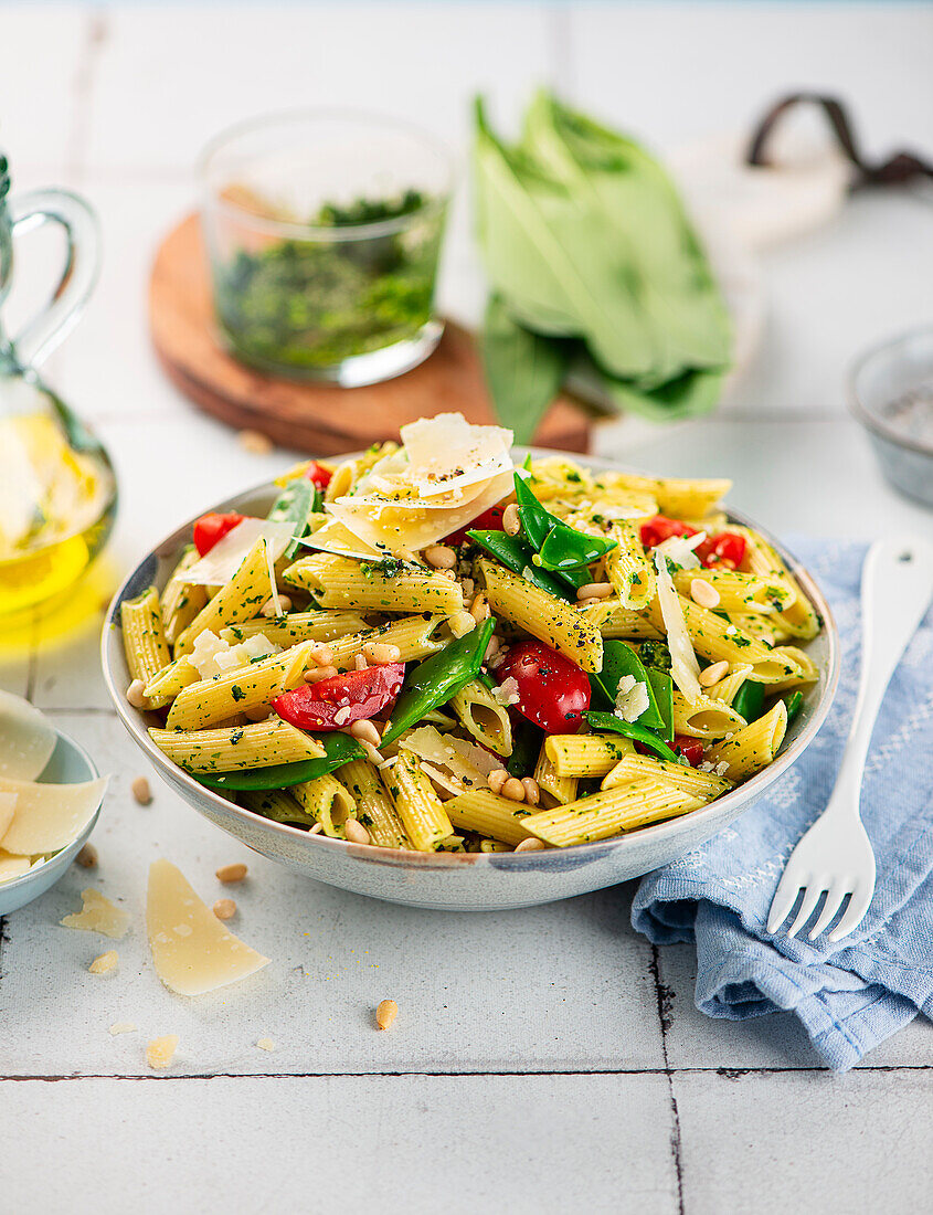 Penne with wild garlic pesto and cherry tomatoes
