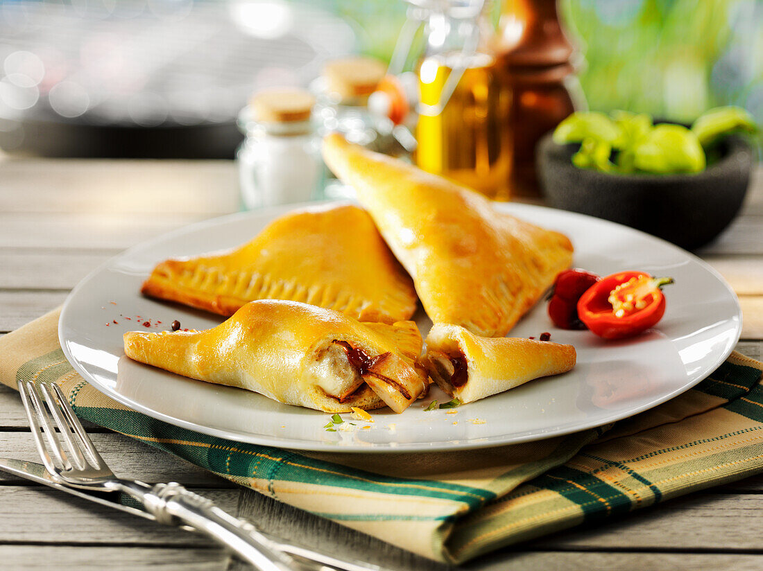 Stuffed pizza pockets with grilled sausages