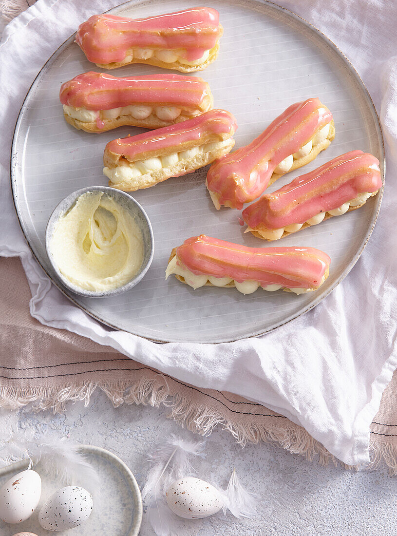 Eclairs with raspberry icing