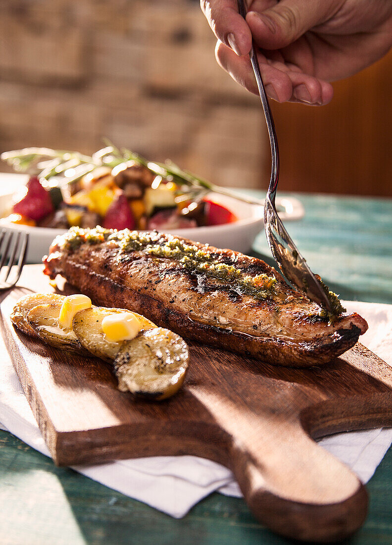 Pork tenderloin served with roast potatoes and vegetables