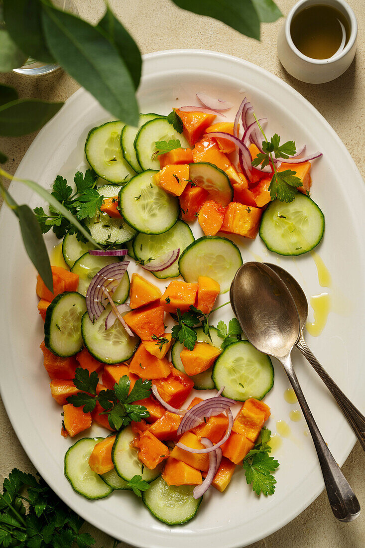 Mexican papaya salad with cucumber and red onions