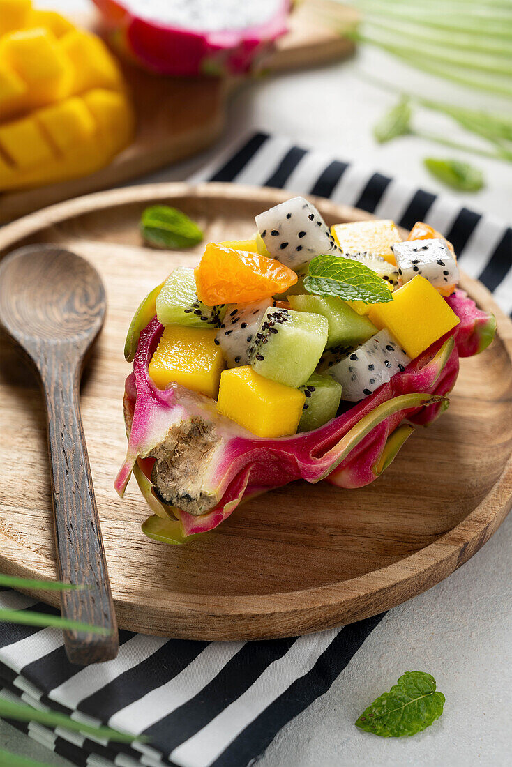 Exotic fruit salad in dragon fruit bowl