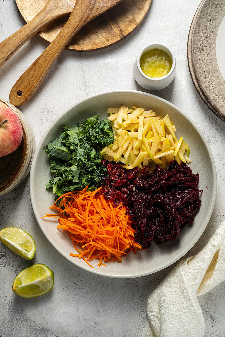 Raw vegetable plate with apple, beetroot, carrots and kale
