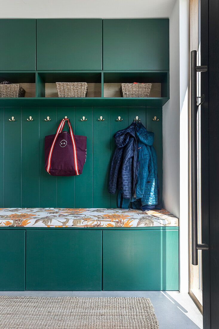 Wardrobe in green with storage space and bench with upholstery