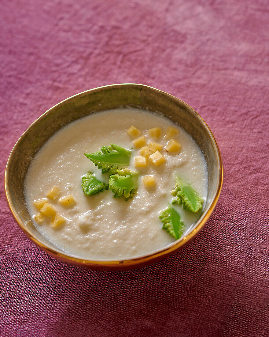 Cream of cauliflower soup with cheese cubes