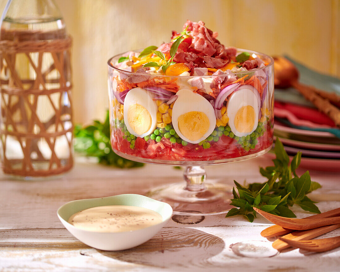 Layered salad with ham and boiled egg