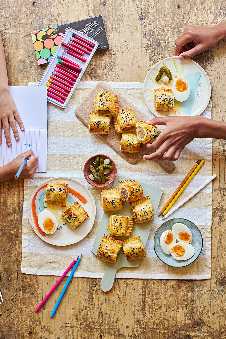 Sausages in pastry, boiled eggs and pickles