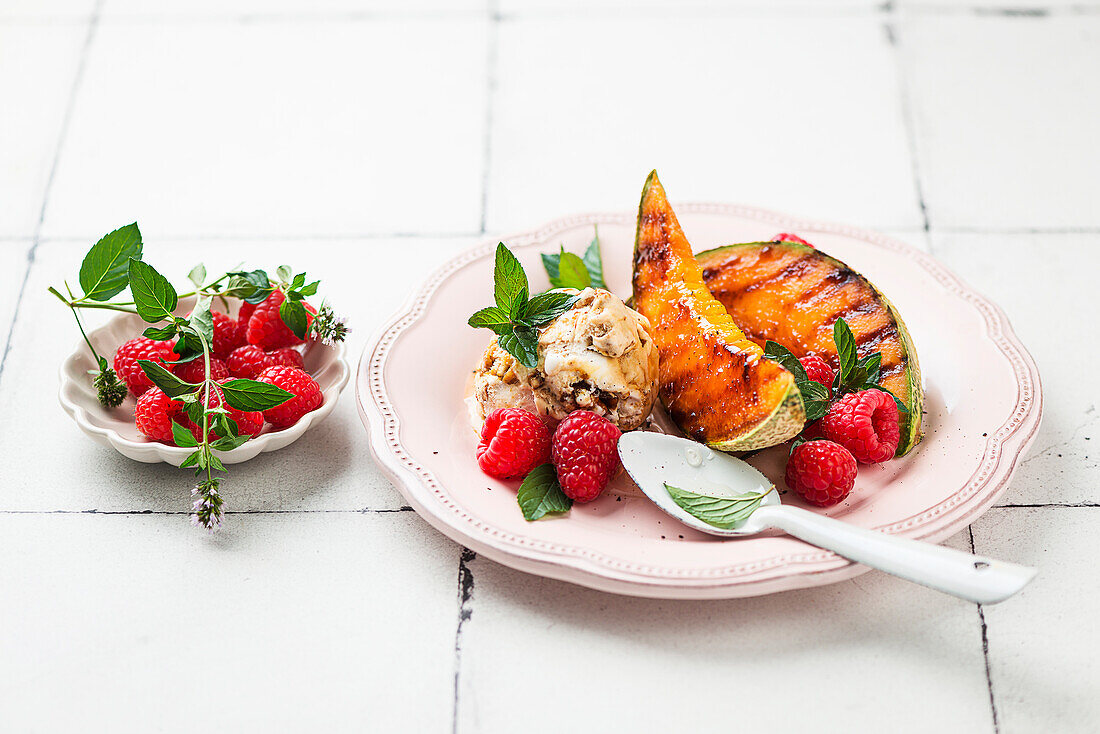 Grilled Charentais melon with ice cream and raspberries