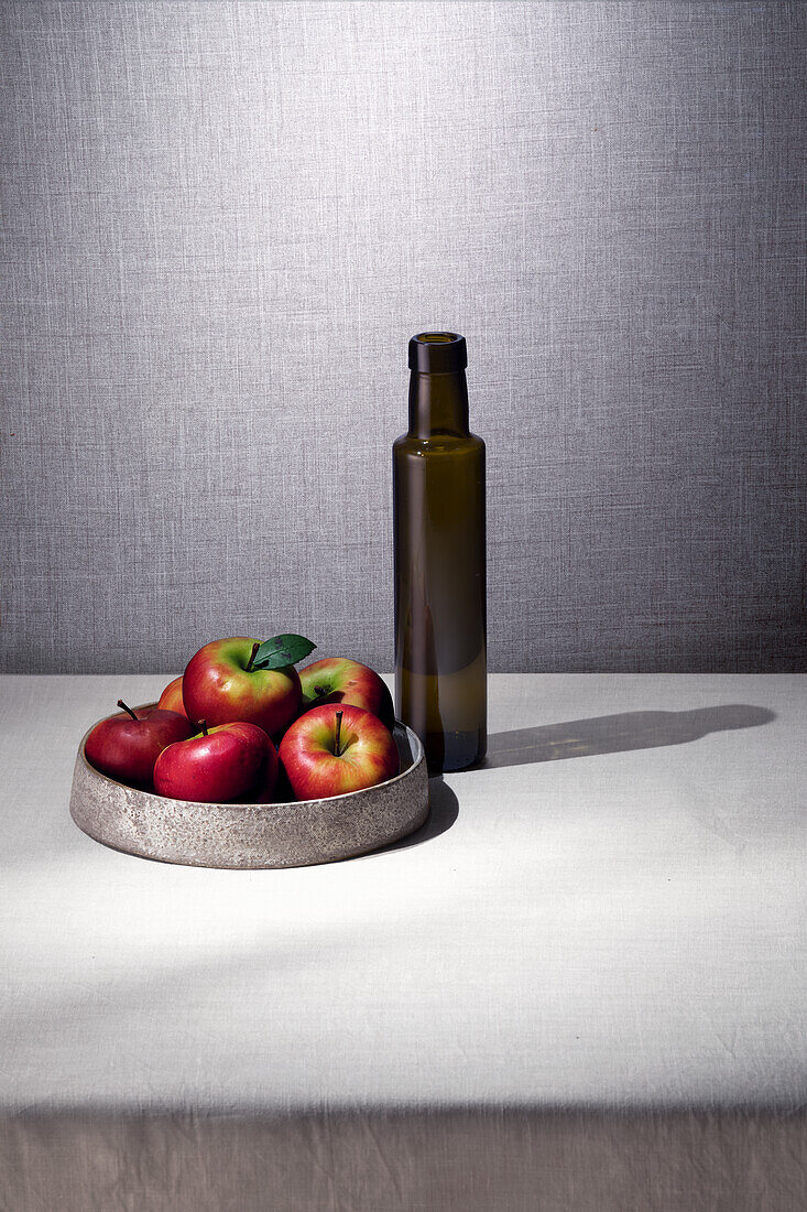 Apples and dark glass bottle