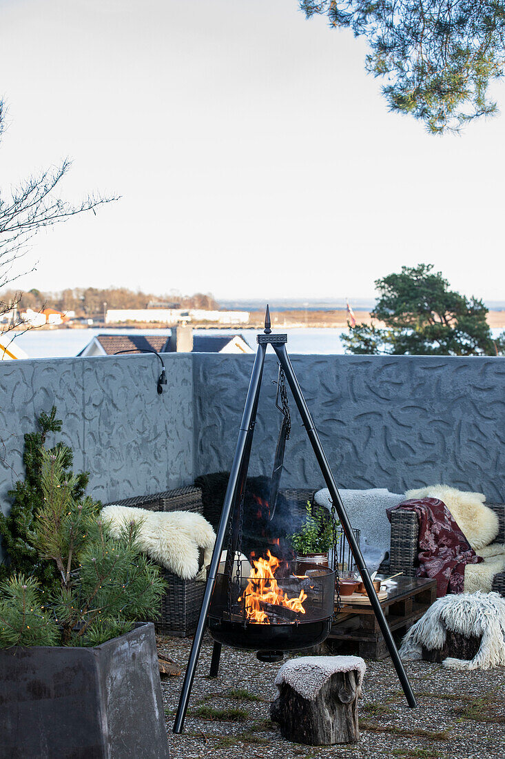 Outdoor fireplace in front of cosy seating area