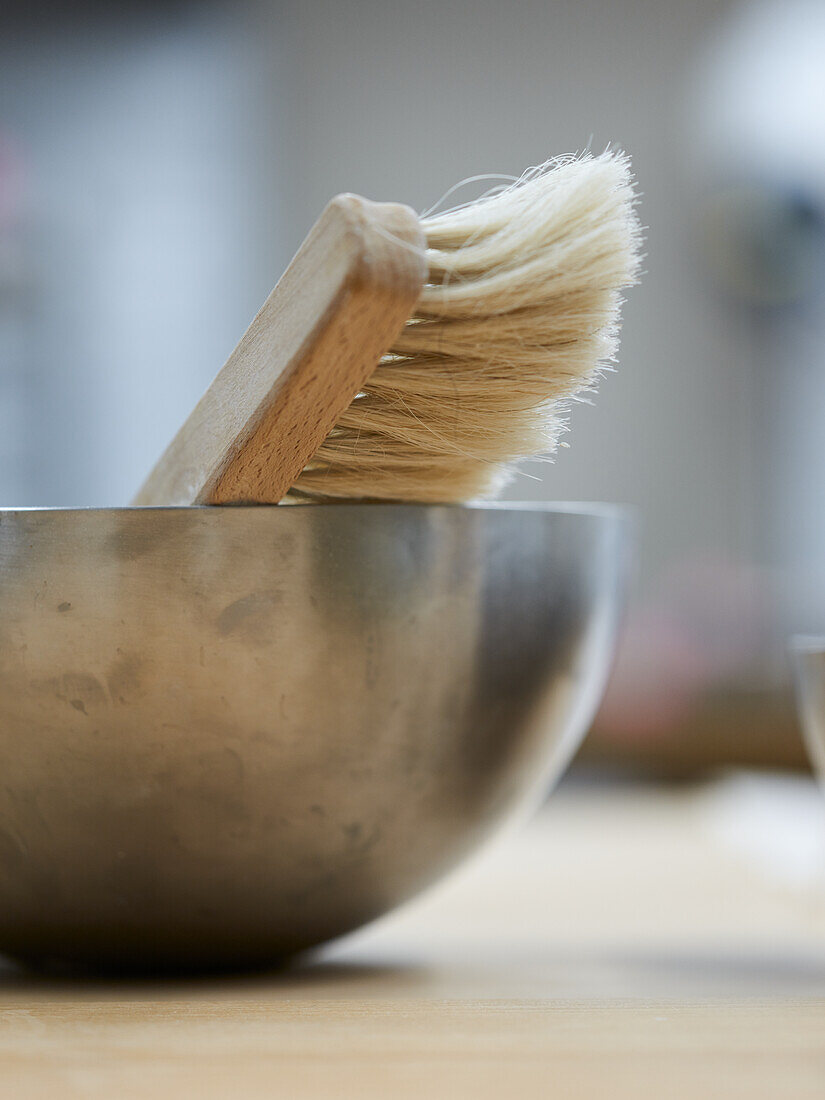 Bread brush in metal bowl