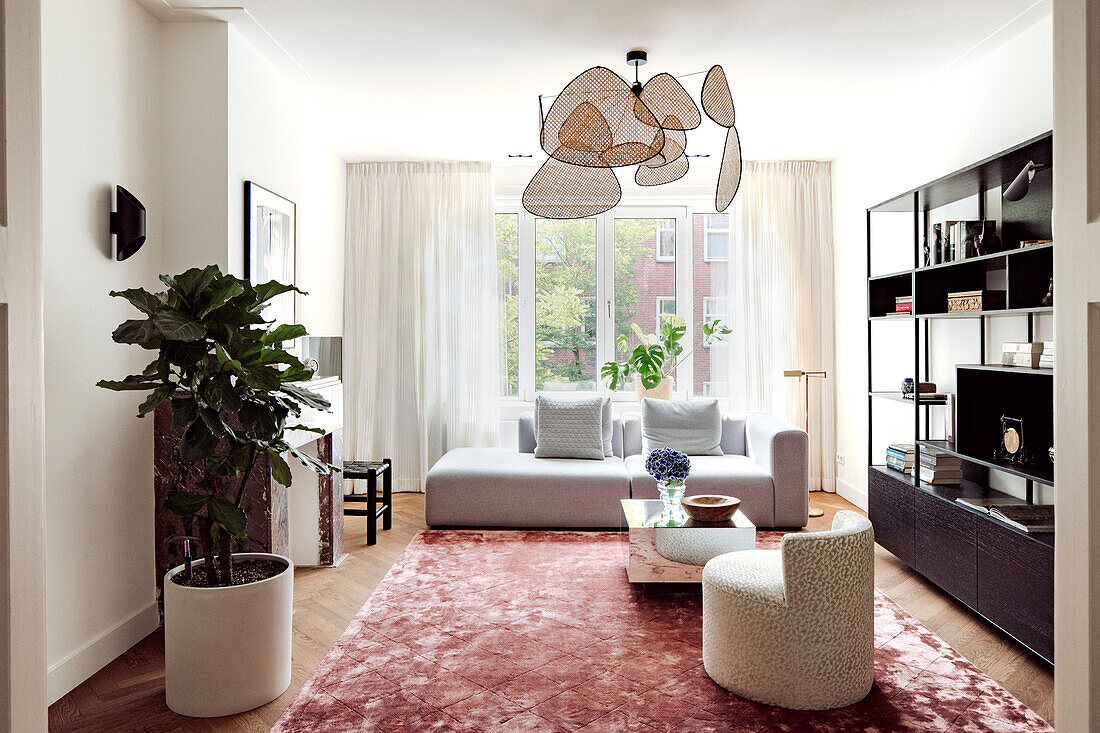 Modern living room with unusual pendant light and pink carpet