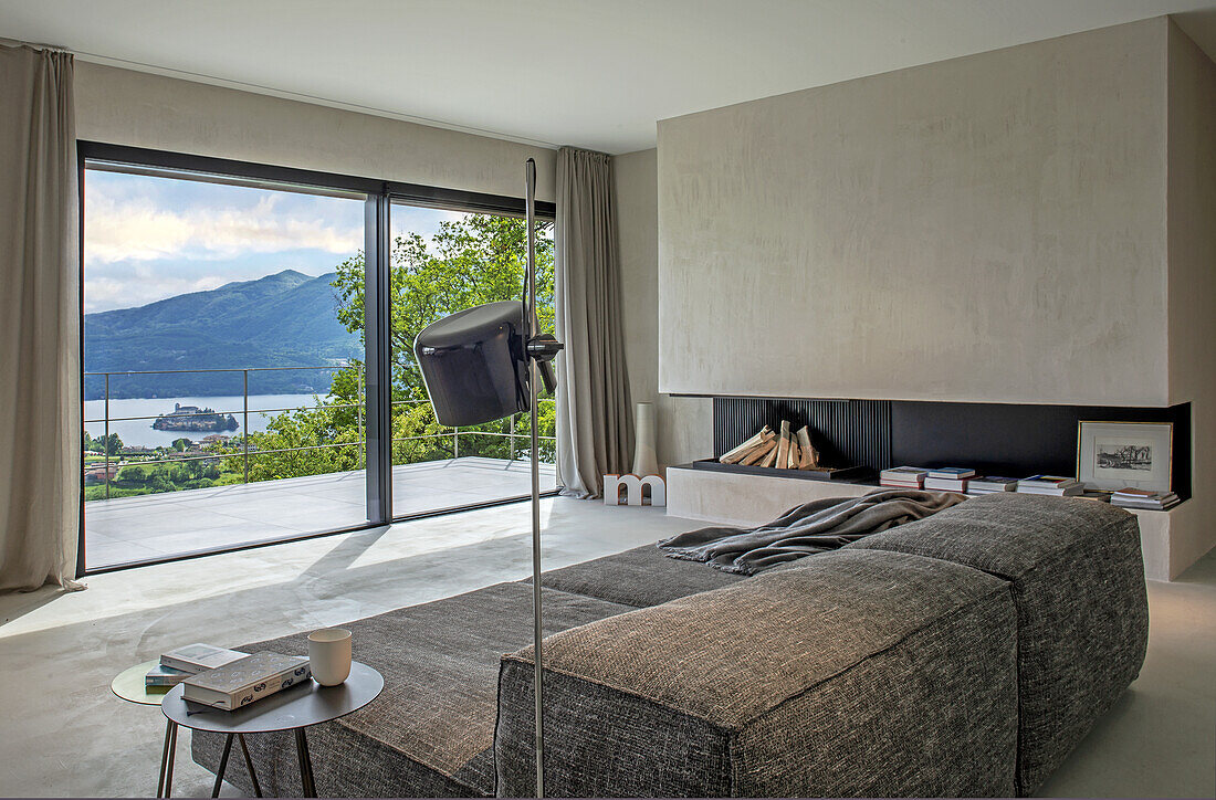 Living room with panoramic window and view of the mountains and lake