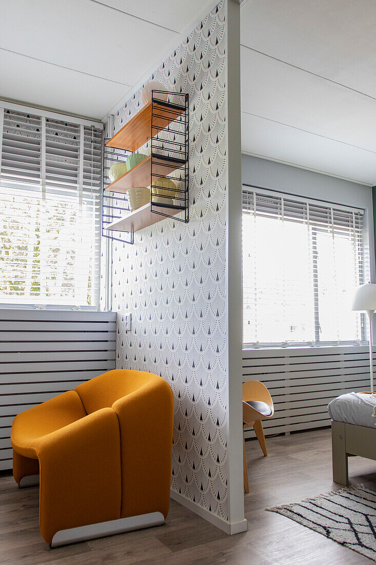 Living room with yellow armchair in front of partition wall